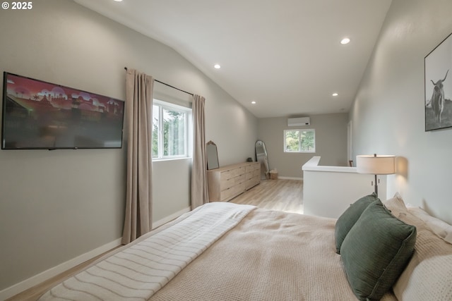 bedroom with lofted ceiling, recessed lighting, light wood-style flooring, an AC wall unit, and baseboards