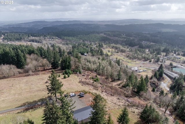 aerial view with a mountain view and a wooded view