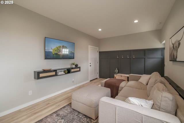 living room featuring wood finished floors, recessed lighting, and baseboards