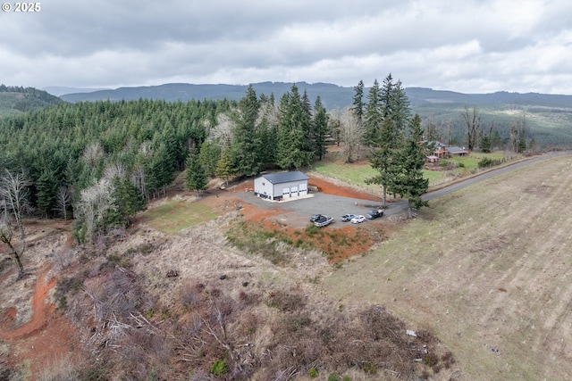 drone / aerial view with a mountain view and a forest view