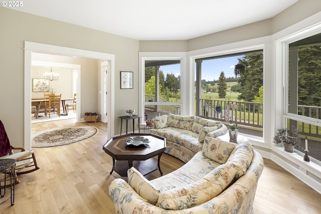 living room featuring a chandelier and hardwood / wood-style floors
