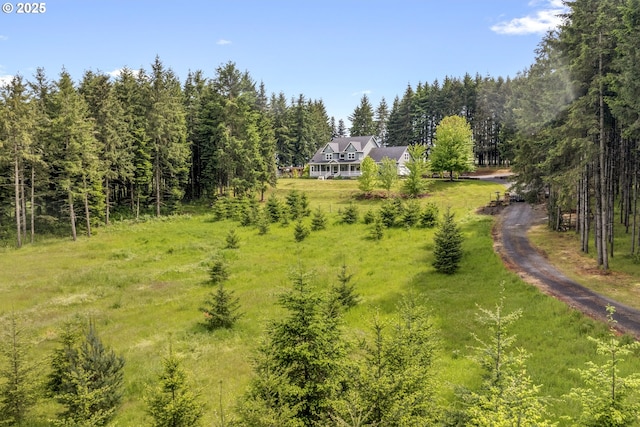 view from above of property featuring a heavily wooded area