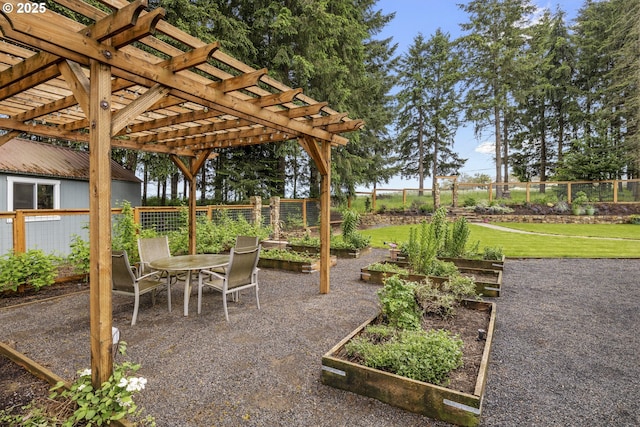 view of patio featuring a garden, a pergola, and outdoor dining area