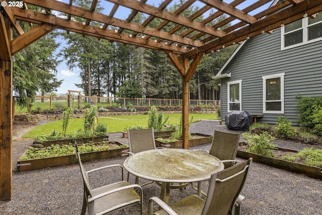 view of patio / terrace featuring a garden, outdoor dining area, and area for grilling