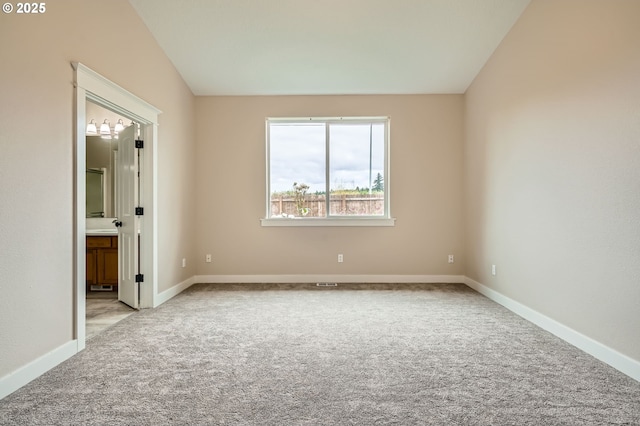 1080 Sage St, Silverton, OR 97381 - unfurnished bedroom with carpet flooring, lofted ceiling, and connected bathroom