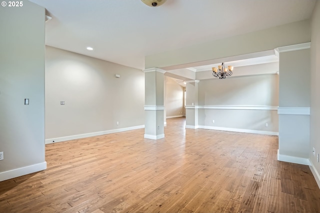 1080 Sage St, Silverton, OR 97381 - unfurnished room featuring a chandelier, light wood-type flooring, decorative columns, and recessed lighting