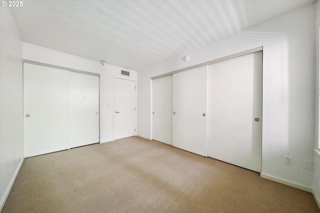 1500 SW Park Ave, Portland, OR 97201 - unfurnished bedroom featuring carpet floors, visible vents, and two closets