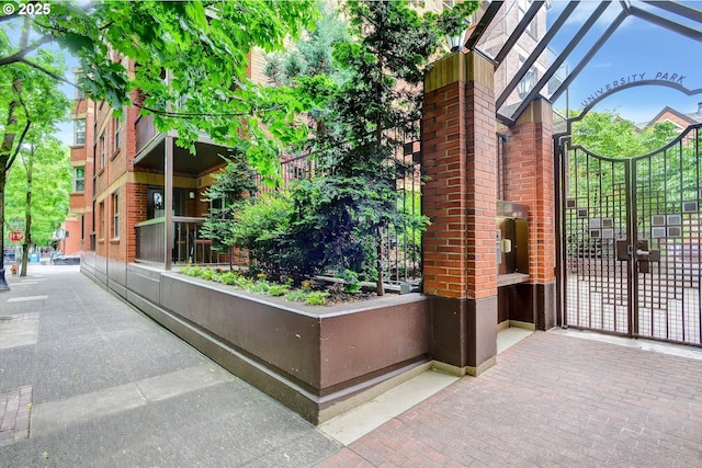 1500 SW Park Ave, Portland, OR 97201 - view of side of home featuring brick siding and a gate