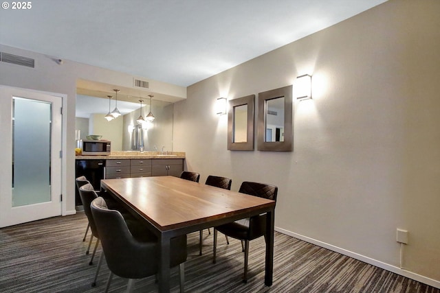 1500 SW Park Ave, Portland, OR 97201 - dining area featuring baseboards, visible vents, and dark carpet