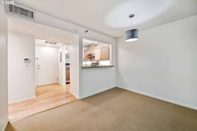 1500 SW Park Ave, Portland, OR 97201 - unfurnished living room with visible vents, baseboards, and light carpet