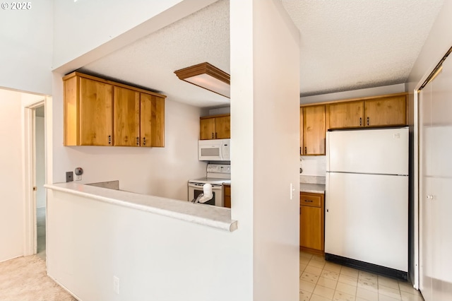 kitchen featuring light countertops, white appliances, and brown cabinets