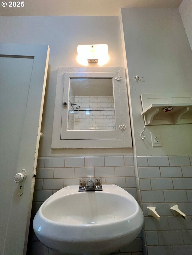 735 SE Spokane St, Portland, OR 97202 - bathroom with a sink, tile walls, and a wainscoted wall
