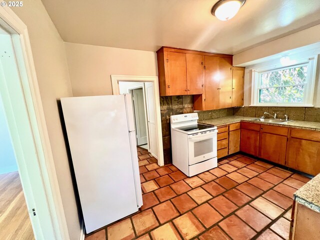 735 SE Spokane St, Portland, OR 97202 - kitchen featuring white appliances, a sink, backsplash, and brown cabinetry