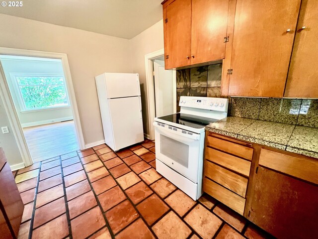 735 SE Spokane St, Portland, OR 97202 - kitchen featuring white appliances, tile countertops, backsplash, brown cabinetry, and baseboards