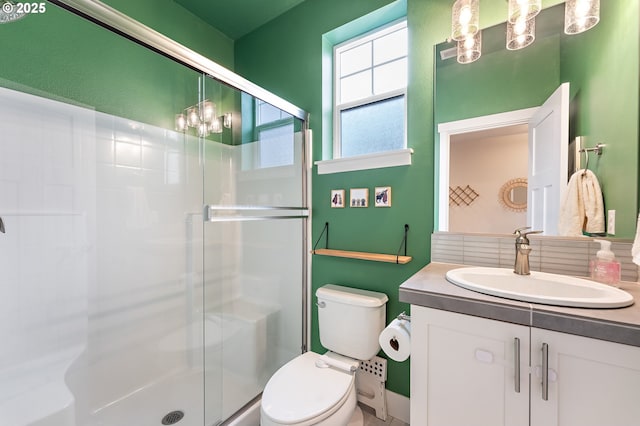 bathroom featuring vanity, toilet, and walk in shower