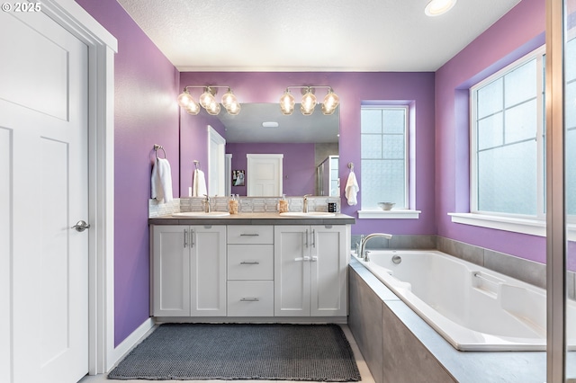 bathroom with vanity, backsplash, and shower with separate bathtub