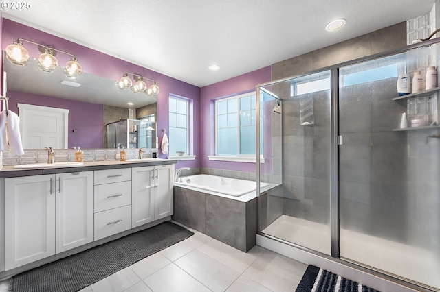 bathroom with vanity, shower with separate bathtub, and tile patterned flooring