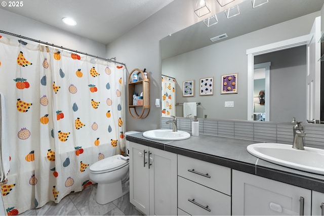 bathroom with vanity, curtained shower, and toilet