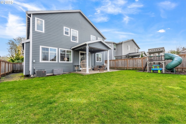 rear view of house with a playground, a yard, a patio area, and central air condition unit