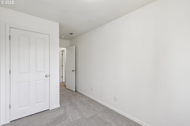 unfurnished bedroom featuring light colored carpet