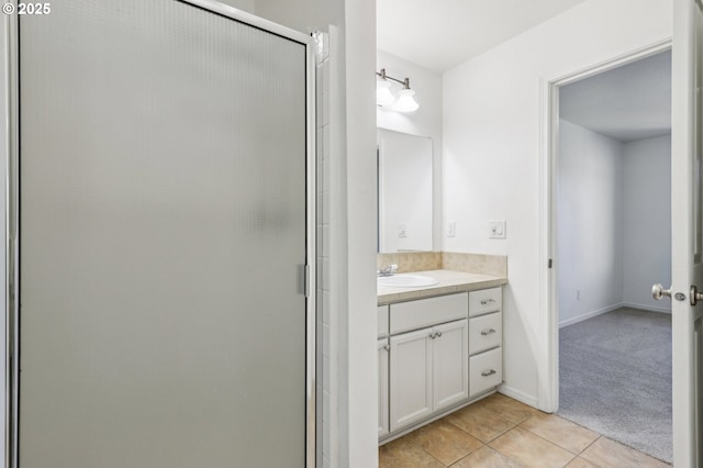 bathroom with vanity, walk in shower, and tile patterned flooring