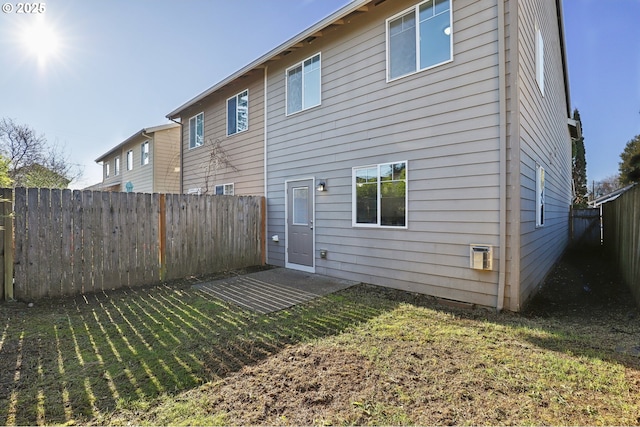 rear view of house featuring a yard