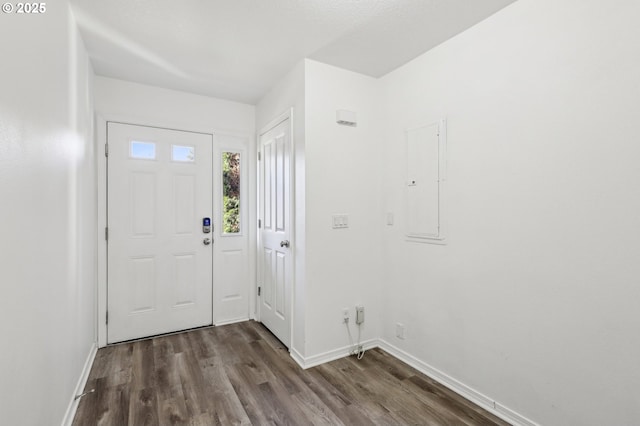 entrance foyer with electric panel and dark hardwood / wood-style floors