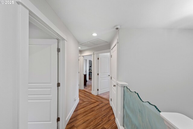 corridor featuring recessed lighting, wood finished floors, and baseboards
