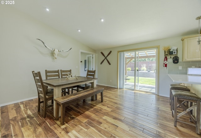 dining space with light wood-style floors, recessed lighting, and lofted ceiling