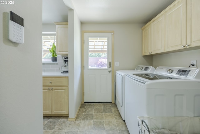 washroom featuring cabinet space and washing machine and clothes dryer
