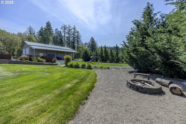 view of yard featuring a fire pit and a playground