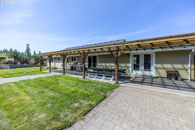 back of house with french doors, fence, a patio, and a yard