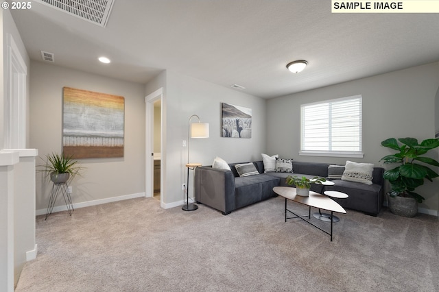 living room featuring carpet floors, baseboards, and recessed lighting