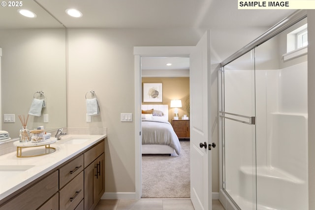 full bathroom with ensuite bath, a stall shower, double vanity, baseboards, and recessed lighting