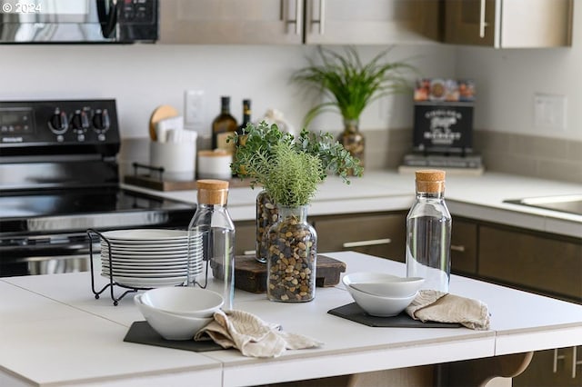 kitchen with black range with electric cooktop and light countertops