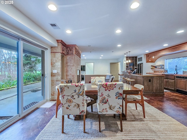 dining area with finished concrete floors, recessed lighting, and visible vents