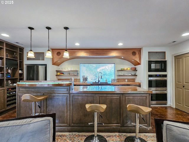 bar with stainless steel double oven, recessed lighting, black microwave, and a sink