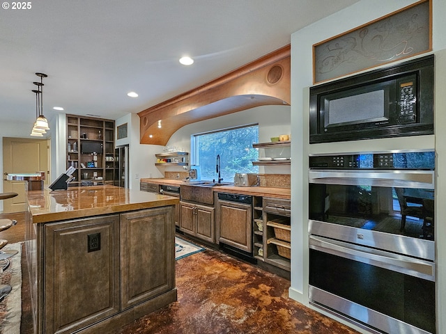 kitchen featuring open shelves, double oven, black microwave, and hanging light fixtures