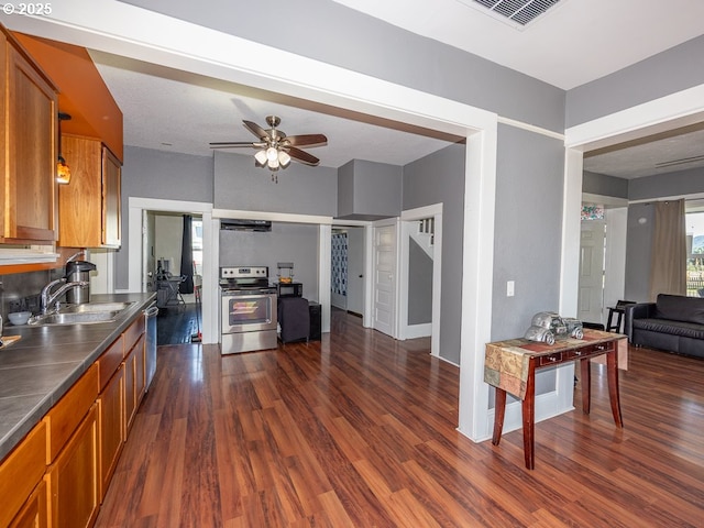 410 E Yacolt Rd, Yacolt, WA 98675 - kitchen featuring stainless steel appliances, brown cabinets, dark wood-type flooring, and a ceiling fan
