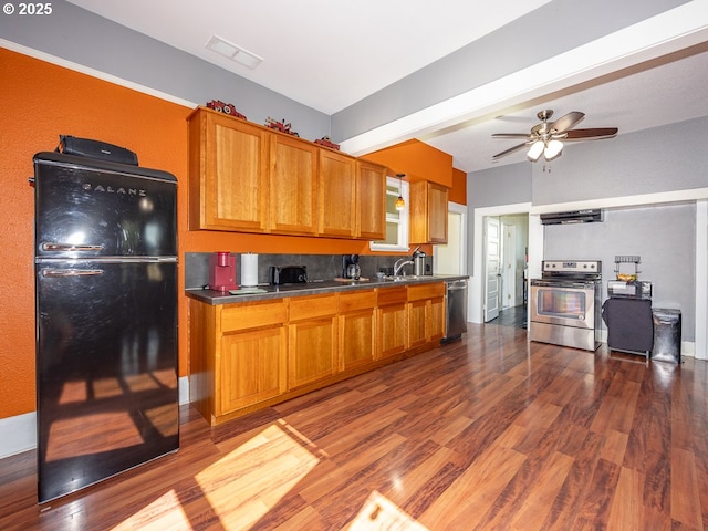 410 E Yacolt Rd, Yacolt, WA 98675 - kitchen with appliances with stainless steel finishes, brown cabinetry, dark wood-style flooring, and ventilation hood