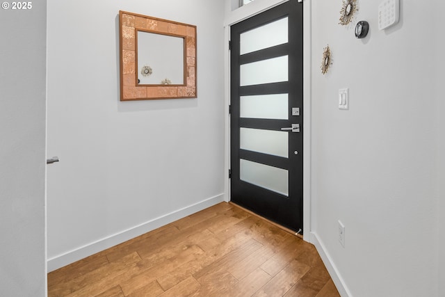 entryway featuring baseboards and light wood finished floors