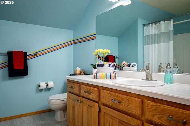 bathroom featuring vanity, curtained shower, lofted ceiling, and toilet