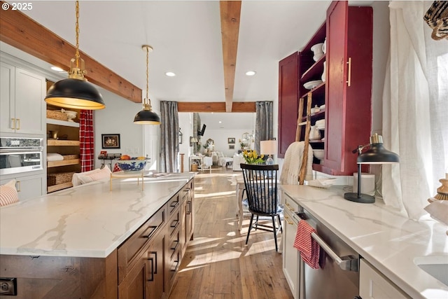 kitchen featuring pendant lighting, stainless steel oven, white cabinets, beamed ceiling, and a large island