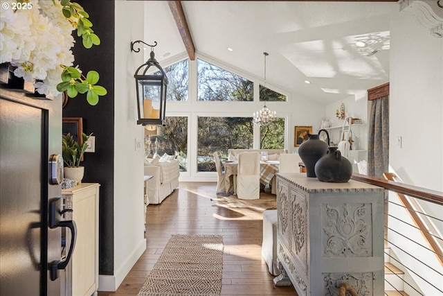 living room with vaulted ceiling with beams, wood-type flooring, and an inviting chandelier