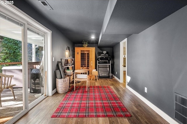 sitting room featuring a wealth of natural light and hardwood / wood-style floors