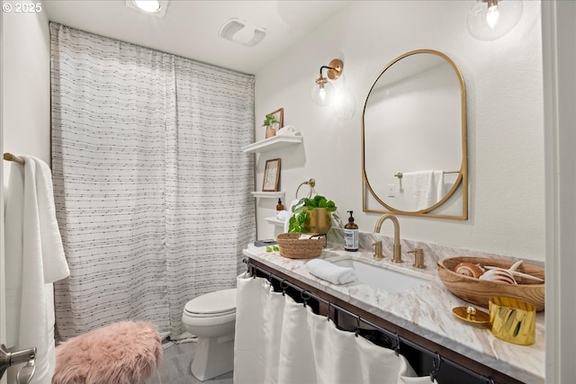 bathroom featuring vanity and toilet