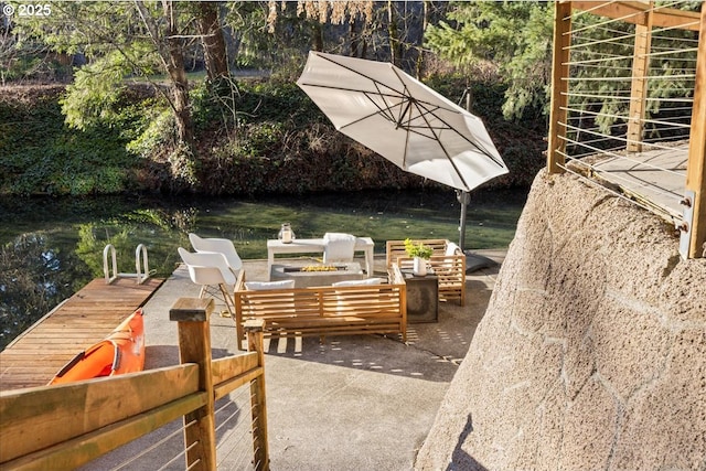 view of patio with a water view and an outdoor hangout area