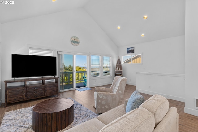 5769 NW Logan Rd, Lincoln City, OR 97367 - living room featuring high vaulted ceiling, recessed lighting, baseboards, and wood finished floors