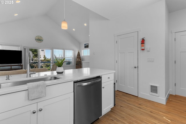 5769 NW Logan Rd, Lincoln City, OR 97367 - kitchen featuring stainless steel dishwasher, a sink, white cabinetry, light wood-type flooring, and decorative light fixtures