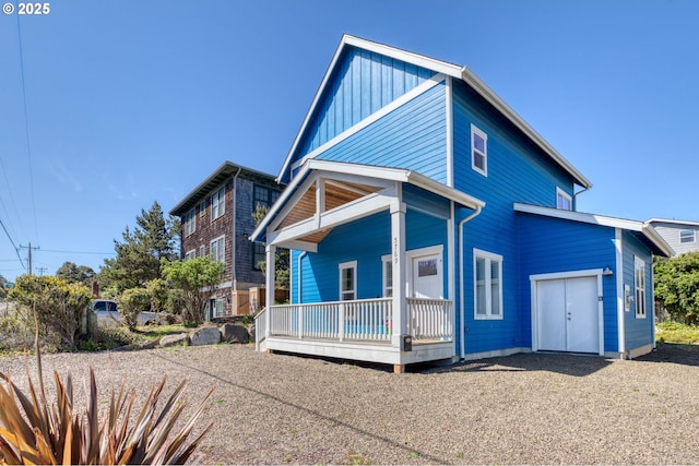 5769 NW Logan Rd, Lincoln City, OR 97367 - view of front facade with a porch, board and batten siding, and driveway